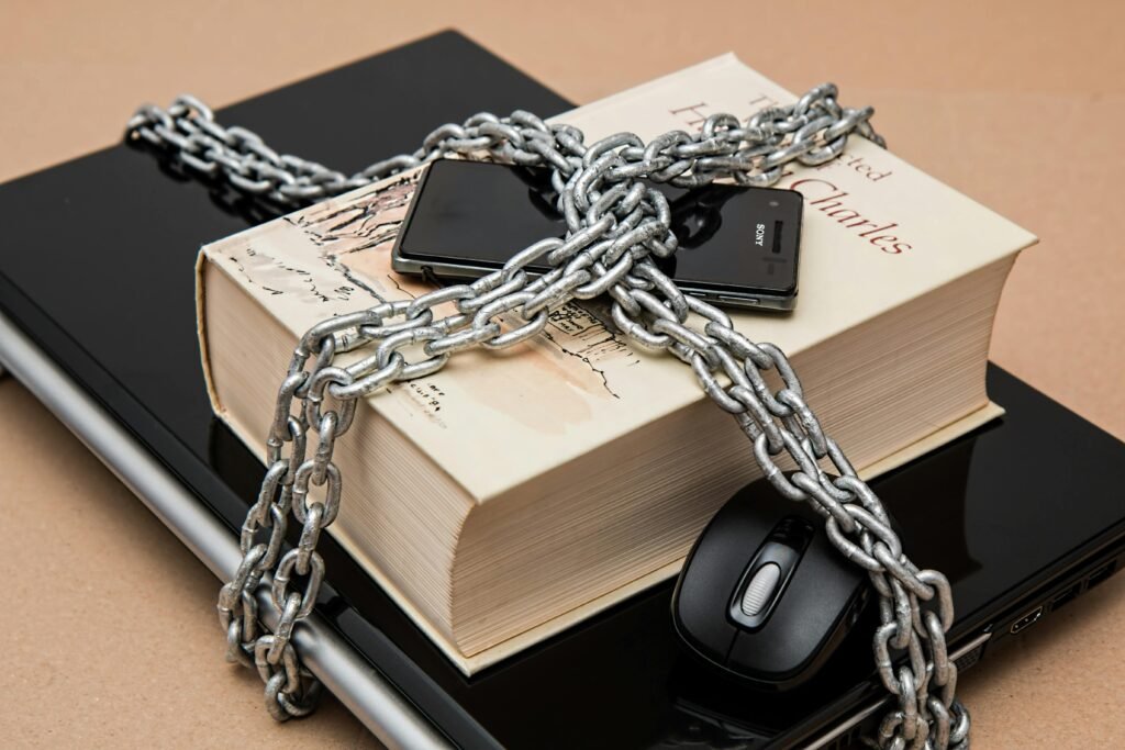 censorship-limitations-freedom-of-expression-restricted-39584-39584 Chain-locked book, phone, and laptop symbolizing digital and intellectual security.